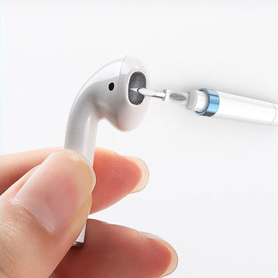 User cleaning earbuds with the trending headphone cleaning pen, showcasing its portable design and effective cleaning capabilities.
